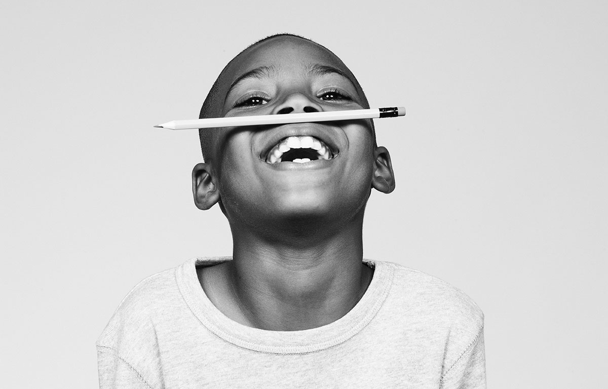 Boy balancing pencil on his upper lip