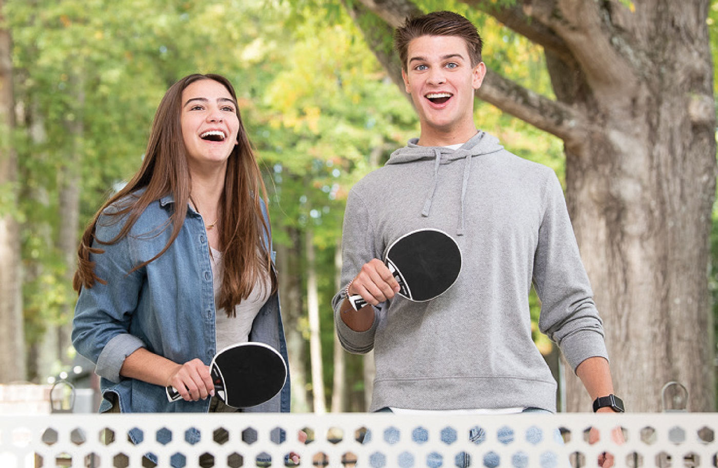 Teenage boy and girl playing table tennis and wearing Damon Ultima Braces