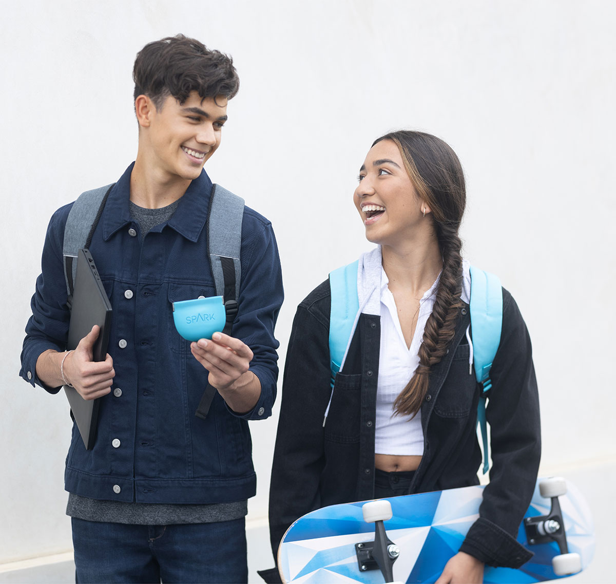 Teenagers laughing and holding Spark Clear Aligner box